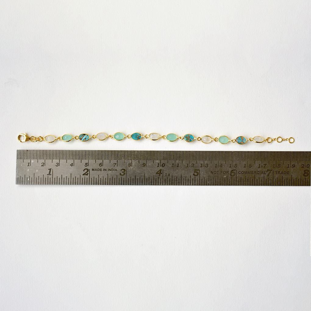 An adjustable silver chain bracelet with vibrant blue stone charms, highlighting its versatile and feminine design.