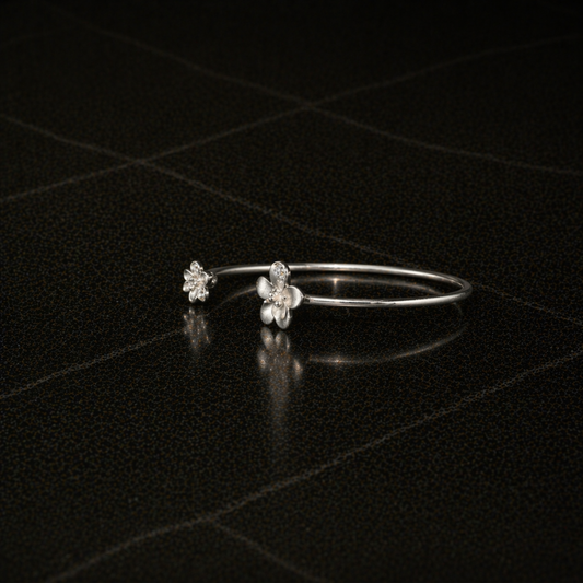 Side view of the handcrafted Floral Spark Bangle in rhodium-plated 925 sterling silver, featuring two CZ-studded flower ends.