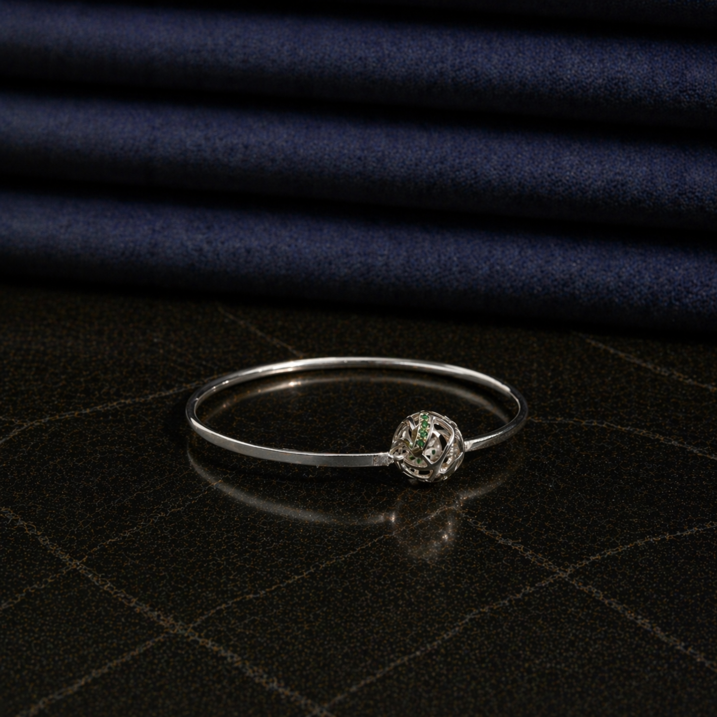 Side perspective of the modern Green Glow Rolling Bangle, showcasing the interactive rolling ball design and polished silver-tone finish.