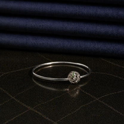 Side perspective of the modern Green Glow Rolling Bangle, showcasing the interactive rolling ball design and polished silver-tone finish.