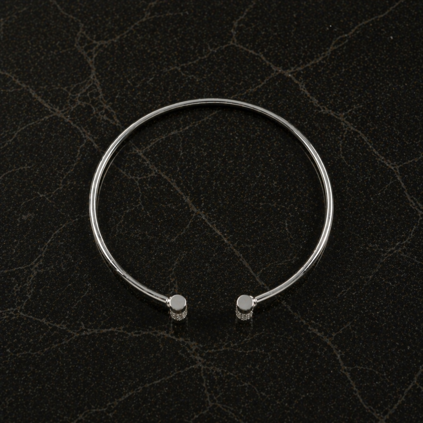 Top-down flat lay of the Sparkle Line Bangle highlighting the 4.24g lightweight sterling silver frame and sparkling silver CZ stone accents.