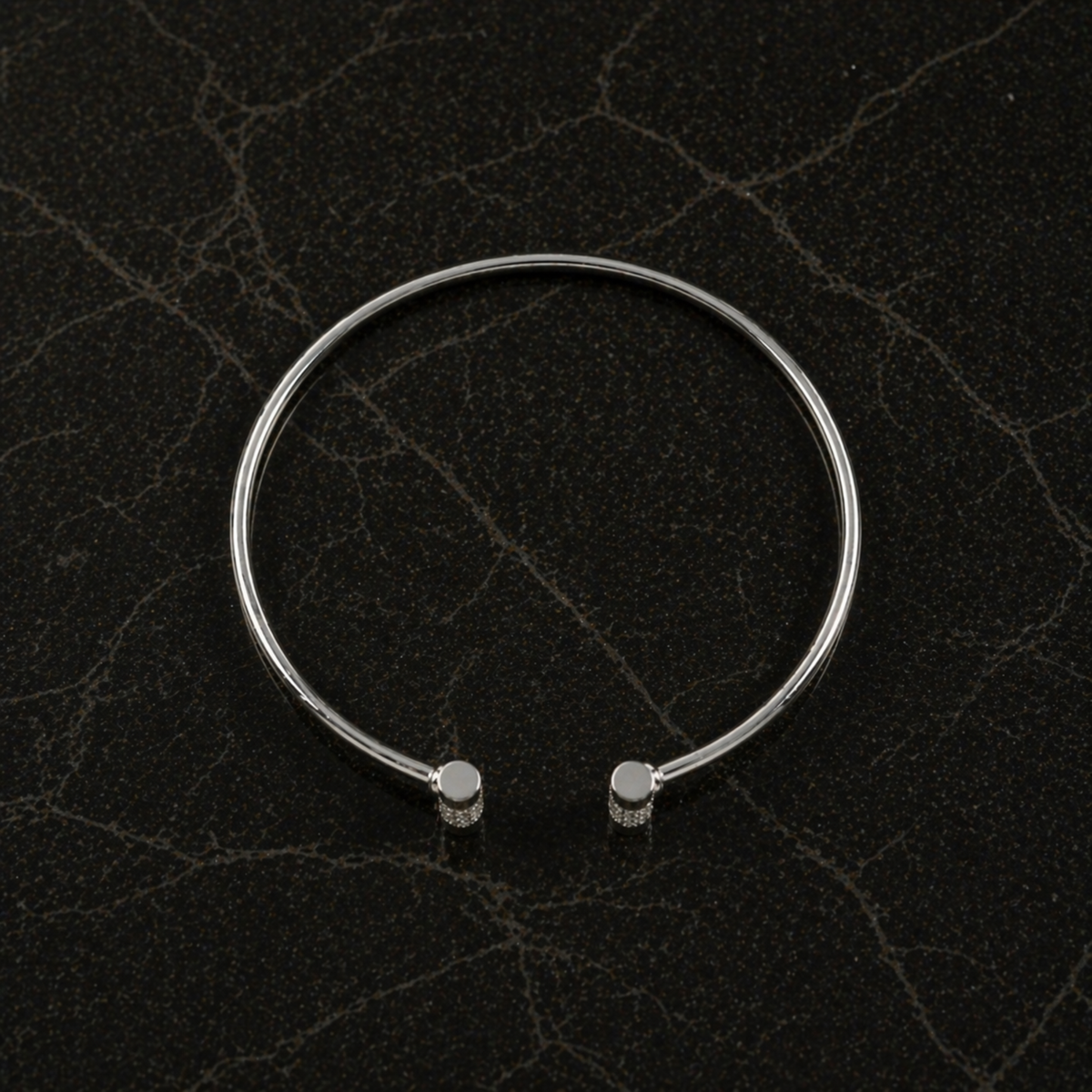 Top-down flat lay of the Sparkle Line Bangle highlighting the 4.24g lightweight sterling silver frame and sparkling silver CZ stone accents.
