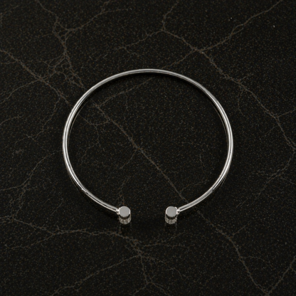 Top-down flat lay of the Sparkle Line Bangle highlighting the 4.24g lightweight sterling silver frame and sparkling silver CZ stone accents.