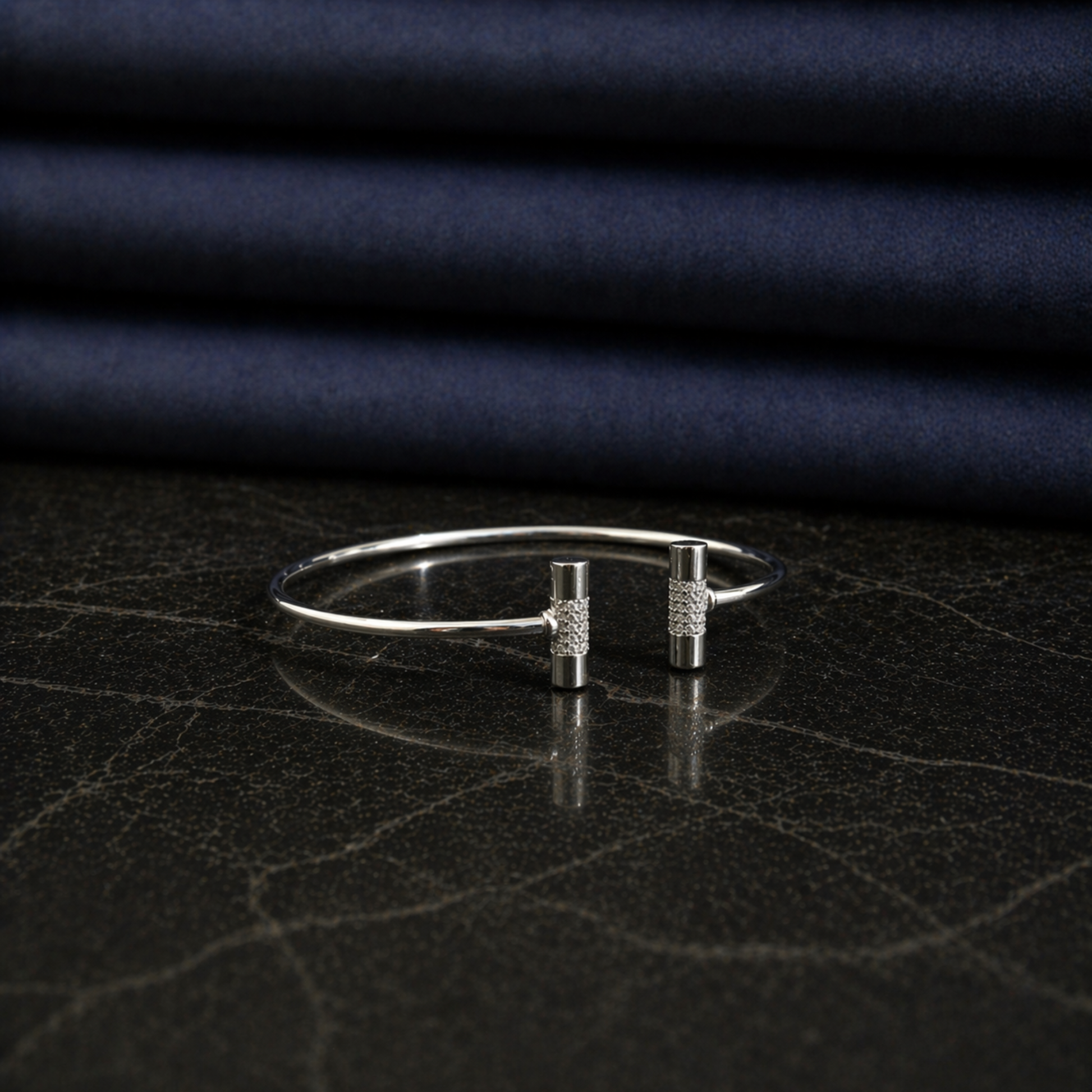 Side profile of the adjustable Sparkle Line Bangle showing the polished finish and minimal modern design on a dark marble background.