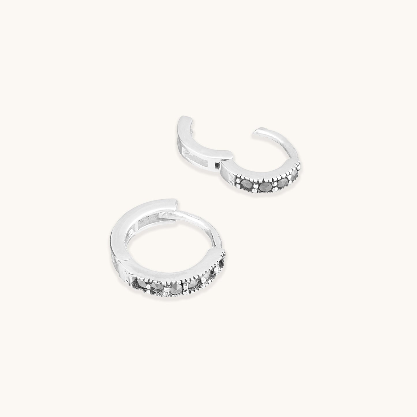 Sterling silver snuggie hoop earrings with black spinel gemstones.