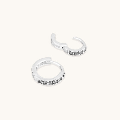 Sterling silver snuggie hoop earrings with black spinel gemstones.