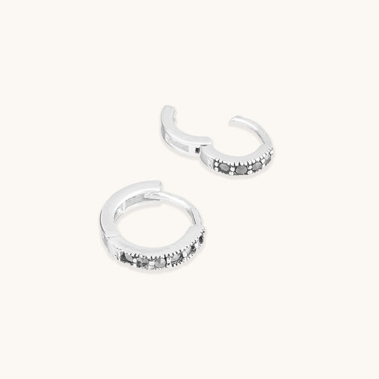 Sterling silver snuggie hoop earrings with black spinel gemstones.