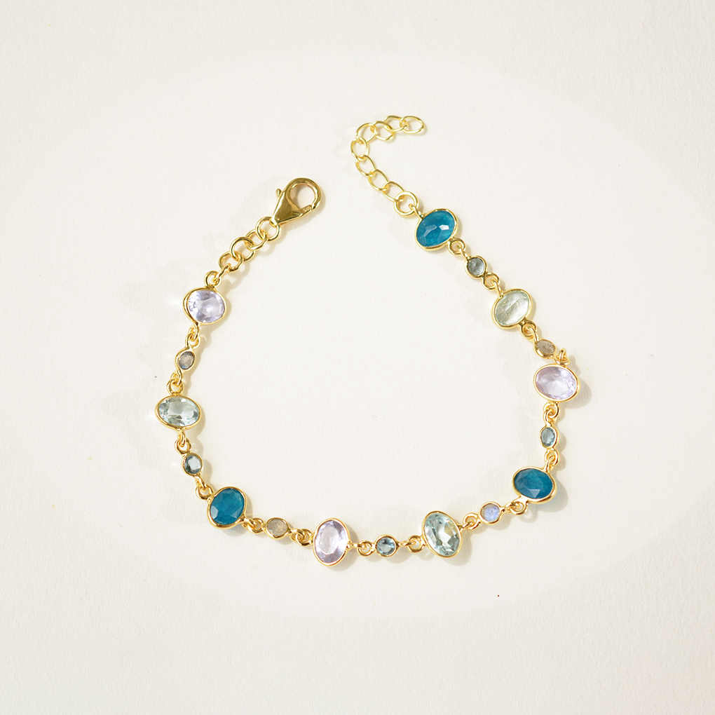 Dainty sterling silver chain bracelet featuring a colorful trio of blue topaz, iolite, and jade gemstones in open bezel settings.