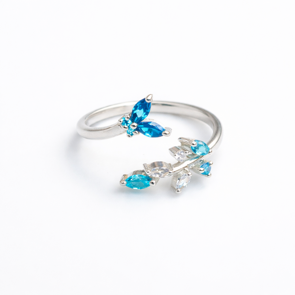 High-polish 925 sterling silver ring featuring a detailed butterfly and flower motif on an adjustable open band.