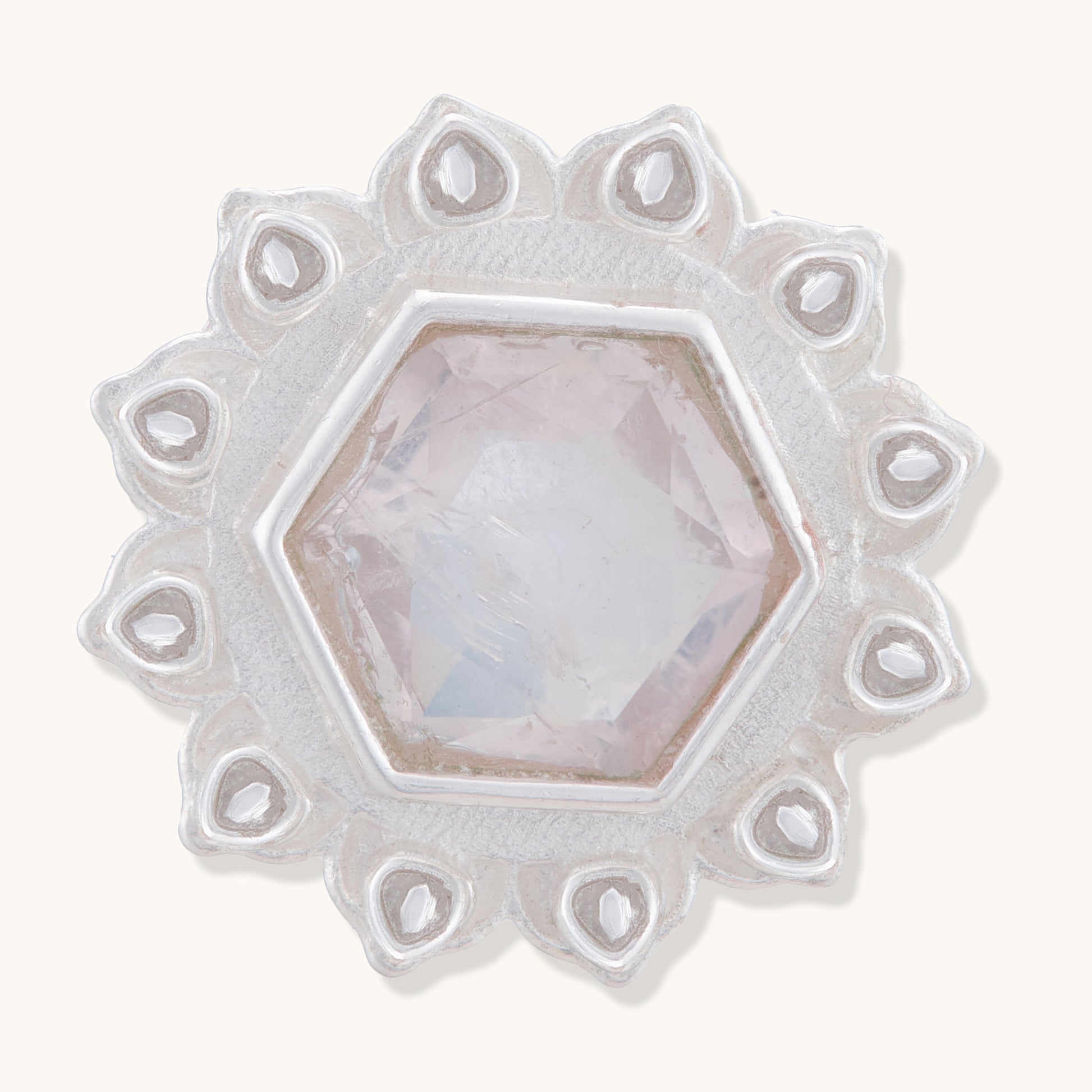 A front view of a silver floral stud earring with a central faceted rose quartz-colored hexagonal stone and intricate petal details.