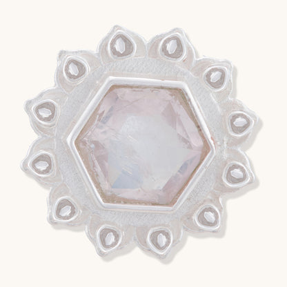 A front view of a silver floral stud earring with a central faceted rose quartz-colored hexagonal stone and intricate petal details.