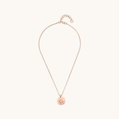 Full view of the Daisy Medallion Necklace, featuring a rose gold circular pendant with an engraved floral daisy design on a delicate link chain.