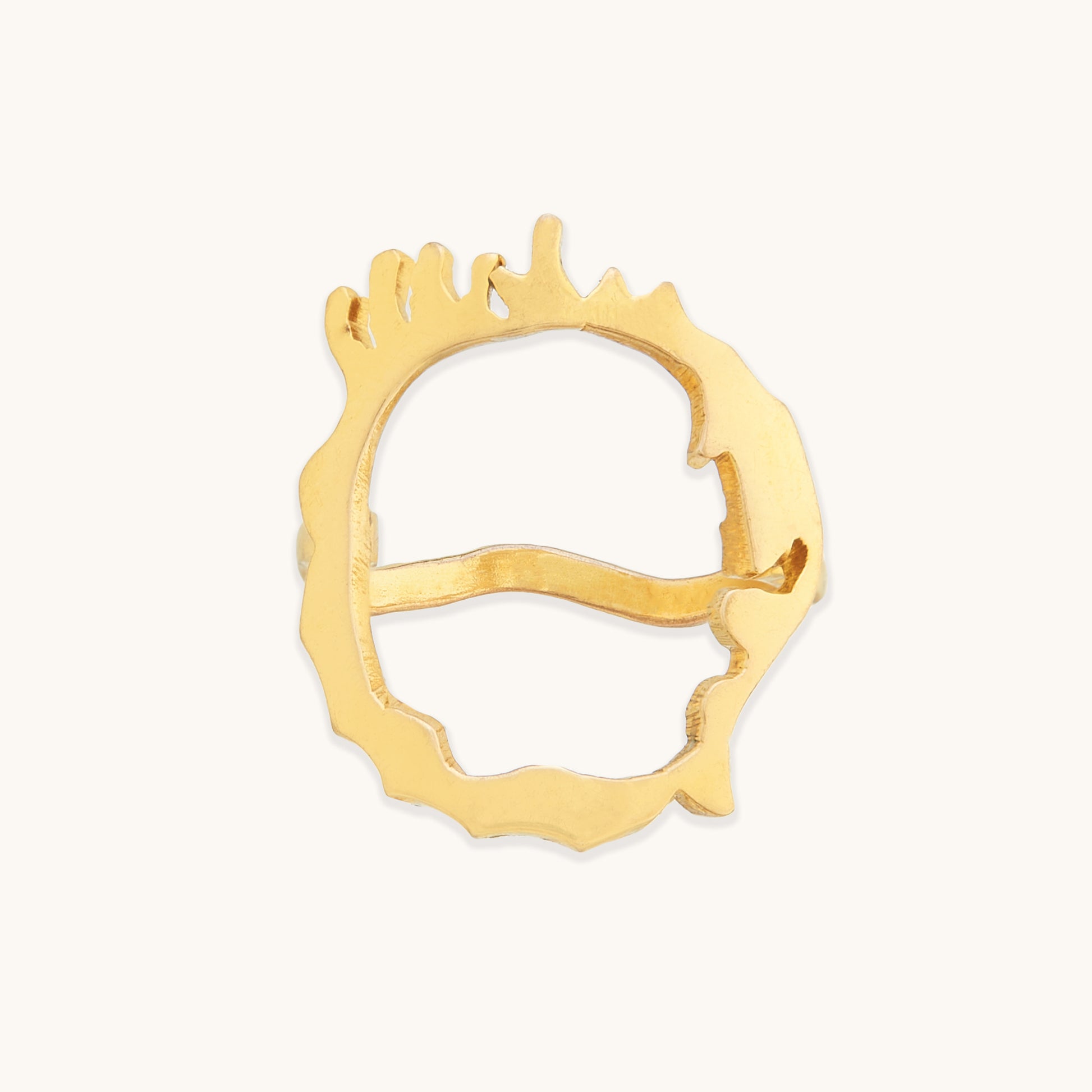 Front view of an irregular gold-tone ring featuring a unique, hand-crafted aesthetic with a series of vertical "drip" accents along the rim.