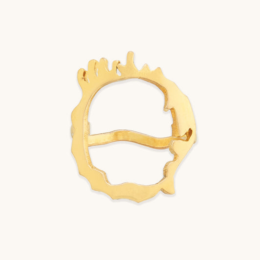 Front view of an irregular gold-tone ring featuring a unique, hand-crafted aesthetic with a series of vertical "drip" accents along the rim.