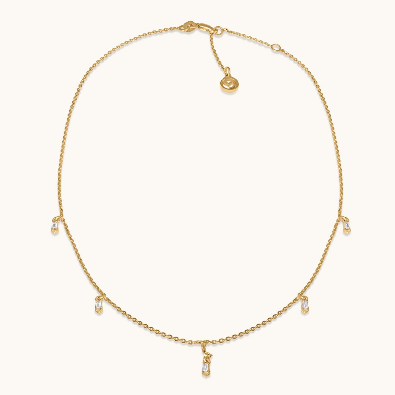A dainty yellow gold chain featuring evenly spaced, small shimmering silver stations that create an airy, minimalist effect, isolated on a white background.