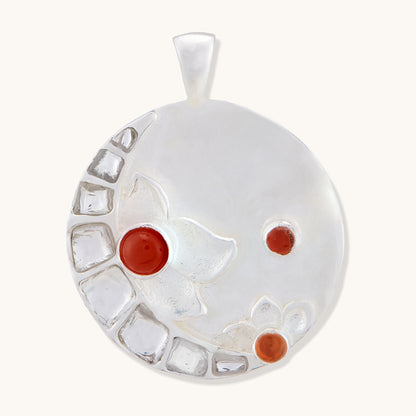 Silver Full Moon pendant featuring inlaid gemstones and intricate floral detailing on a white background.