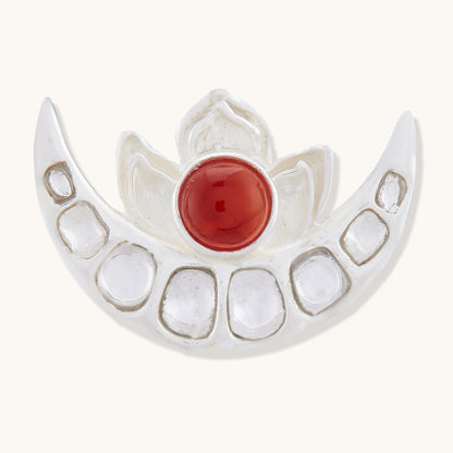 Sterling silver half-moon pendant featuring a central red gemstone and embedded clear stones along the crescent edge, isolated on a white background.