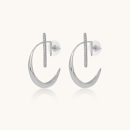 A pair of platinum crescent moon drop earrings with a modern geometric diamond-set bar and secure push-back closures.