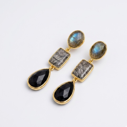 Handcrafted 18kt gold-plated Midnight Elegance earrings with a unique three-stone drop design of Black Rutile and Onyx, displayed in natural lighting.