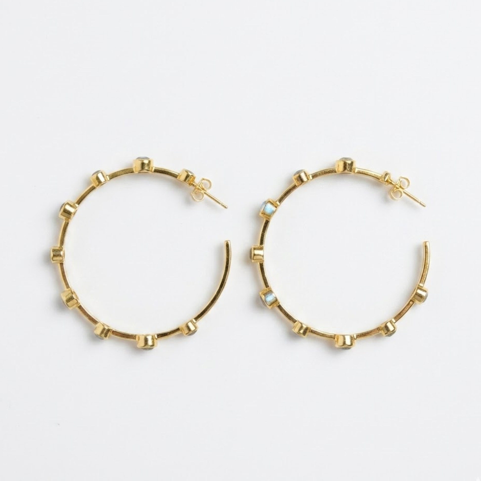 Studio flat lay of the Moonspell Layers multi-stone earrings on a white background, featuring the secure pushback stud closure.