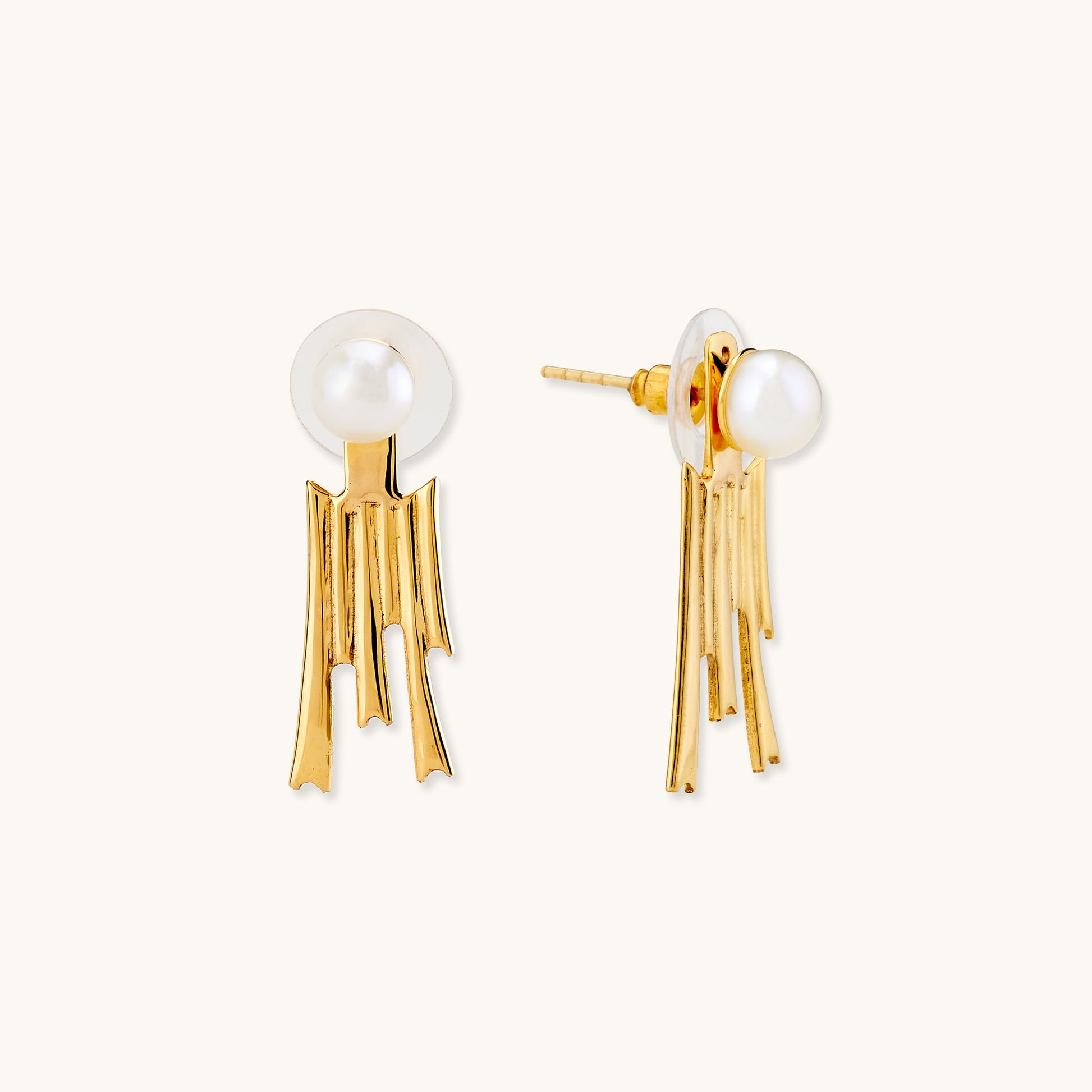 Gold earrings featuring a round white pearl stud and a dangling textured fringe pendant.