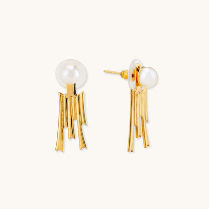 Gold earrings featuring a round white pearl stud and a dangling textured fringe pendant.