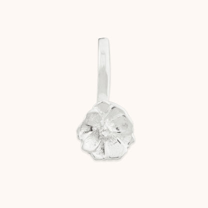 Close-up of a delicate, hand-crafted floral silver nose clip-on featuring textured, organic petal details against a neutral background.