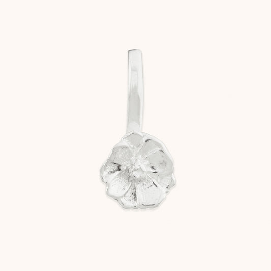 Close-up of a delicate, hand-crafted floral silver nose clip-on featuring textured, organic petal details against a neutral background.