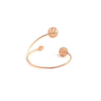 A rose gold open-style bracelet designed with two decorative, hollow spherical charms and a single pearl, isolated on a white background.