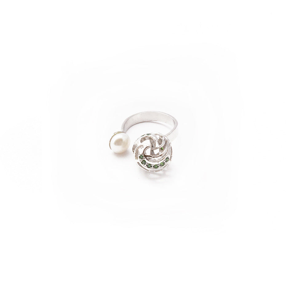 Close-up of a refined, minimalist silver-toned ring showcasing a smooth, iridescent pearl, highlighting its elegant craftsmanship and clean aesthetic.