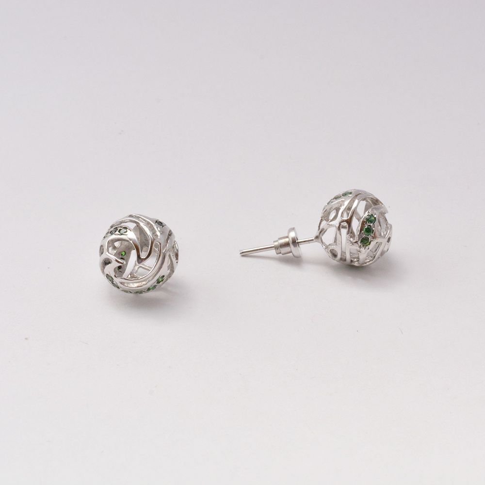 Handcrafted white rhodium-plated brass stud earrings featuring intricate wave-inspired jali lattice work and sparkling cubic zirconia in ocean blue and green hues.