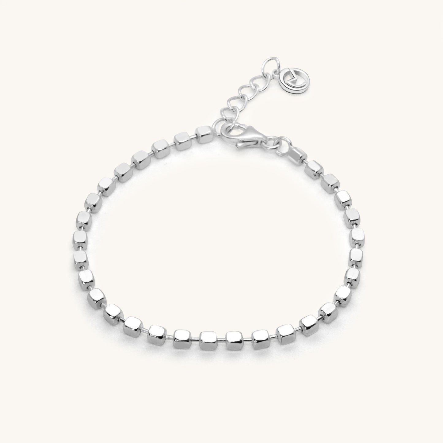 Minimalist silver chain bracelet featuring a continuous row of small, polished square-shaped beads and a secure lobster clasp.