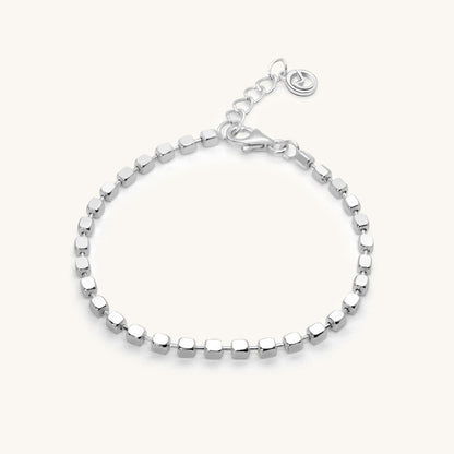 Minimalist silver chain bracelet featuring a continuous row of small, polished square-shaped beads and a secure lobster clasp.
