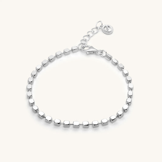 Minimalist silver chain bracelet featuring a continuous row of small, polished square-shaped beads and a secure lobster clasp.