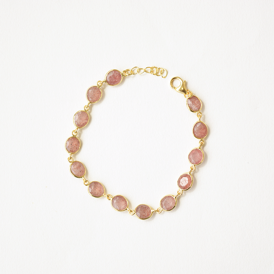 Dainty sterling silver chain bracelet featuring a polished red-speckled gemstone in an open bezel setting.