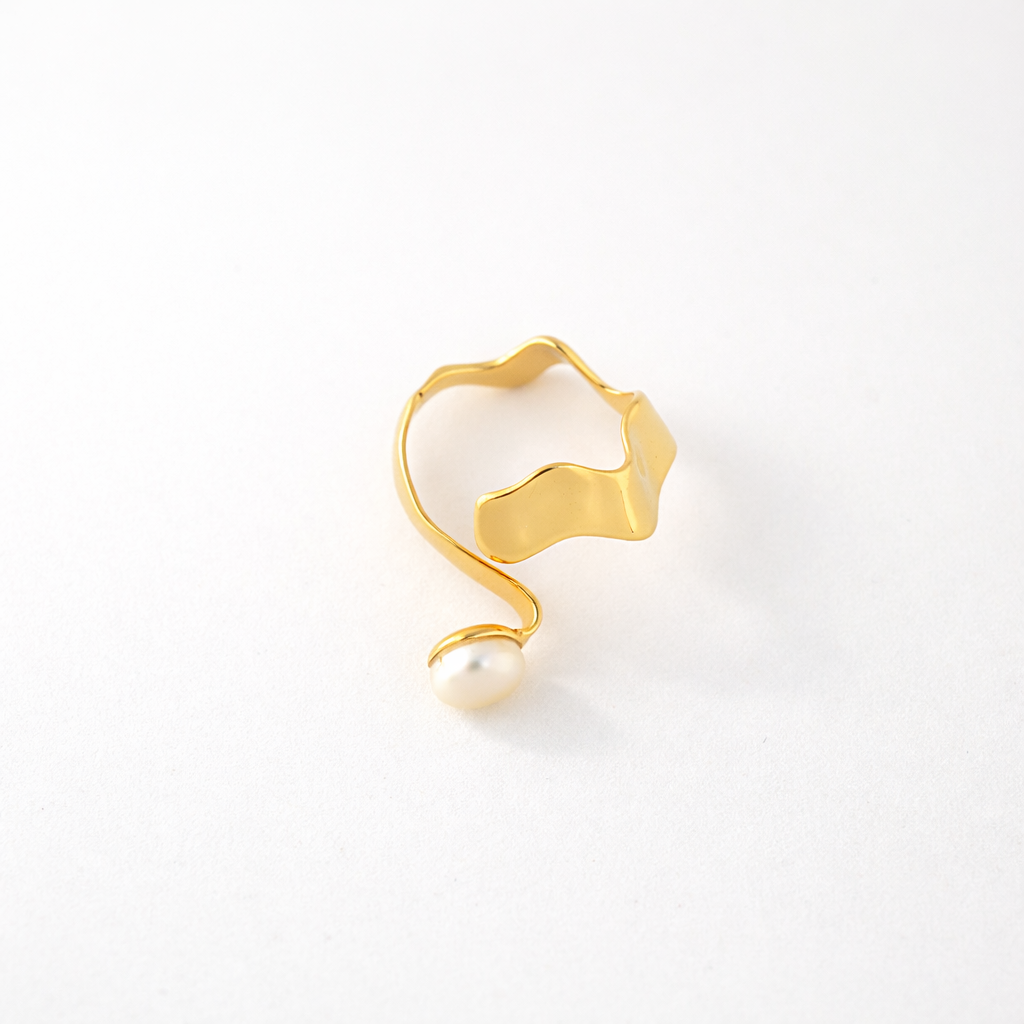 Studio shot of an irregular, wavy gold-toned band featuring a continuous, fluid design on a clean white background.