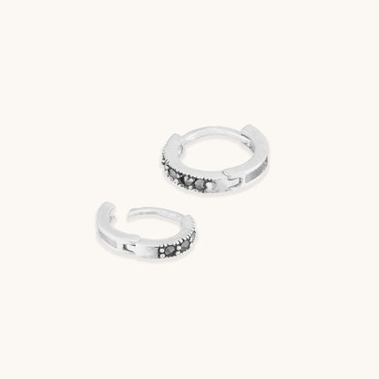 Featuring a row of pave-set dark grey or black stones along the front edge.