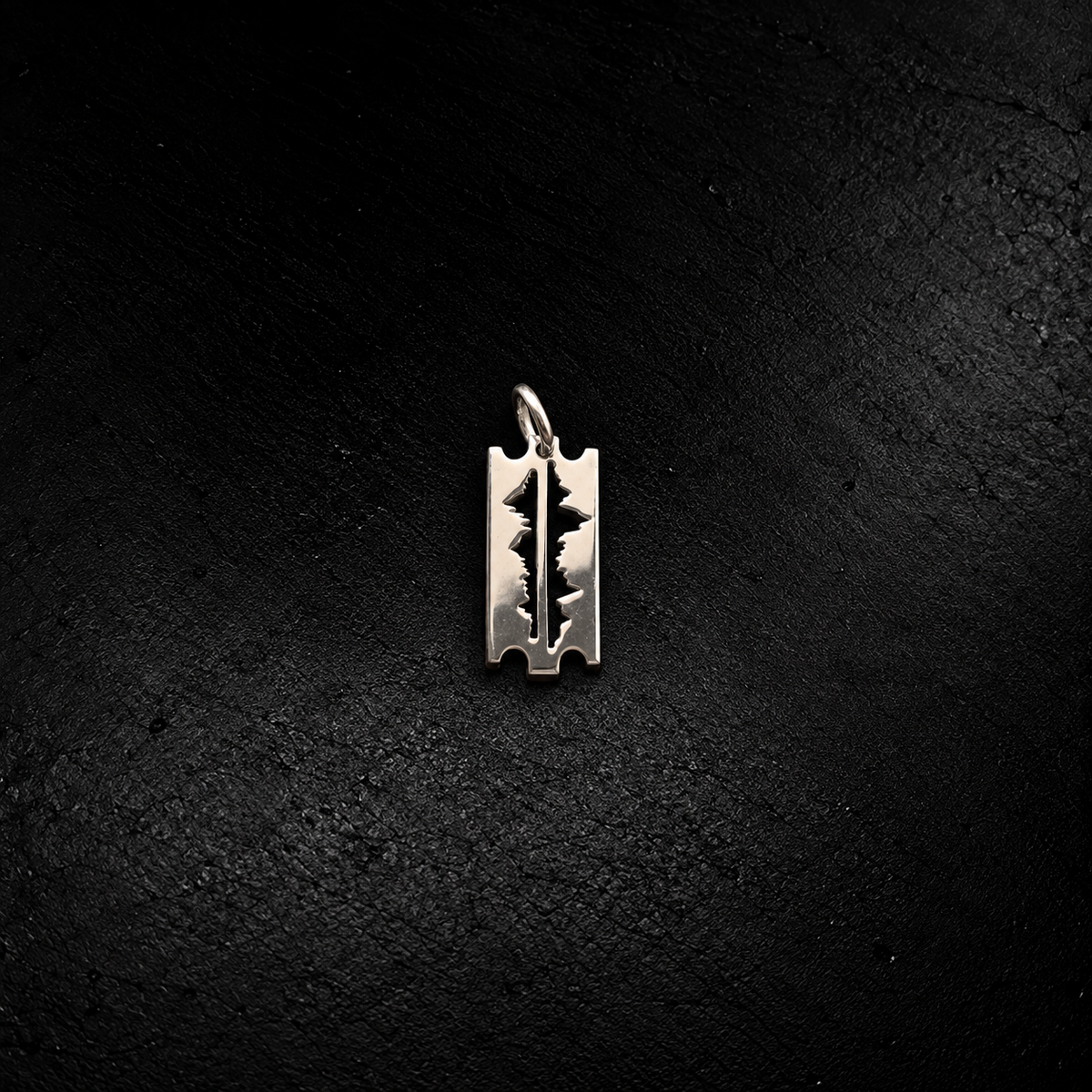 Mountains Are My Lifeline small pendant in 925 silver – razor-blade shape with mountain-peak cut-out, on black slate