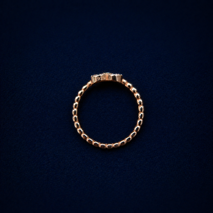 Rear view of the handcrafted A Little Love Ring on a dark navy background, highlighting the authentic 925 sterling silver stamp on the rose gold plated band.