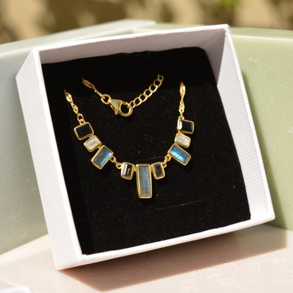 A handcrafted 18kt gold plated A Story of Stones necklace featuring natural labradorite, moonstone, and black onyx rectangular links, presented in a luxury white MAREECI gift box.
