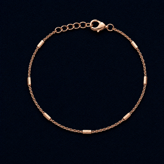 A full circular view of the Bar Rhythm bracelet featuring seven polished rose gold-plated rectangular bars on a delicate chain with an adjustable clasp, displayed on a dark navy background.