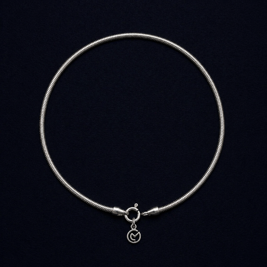 Full circular view of the Bare Shine 925 sterling silver snake chain anklet, featuring a sleek and fluid handcrafted design with a flat polished finish.