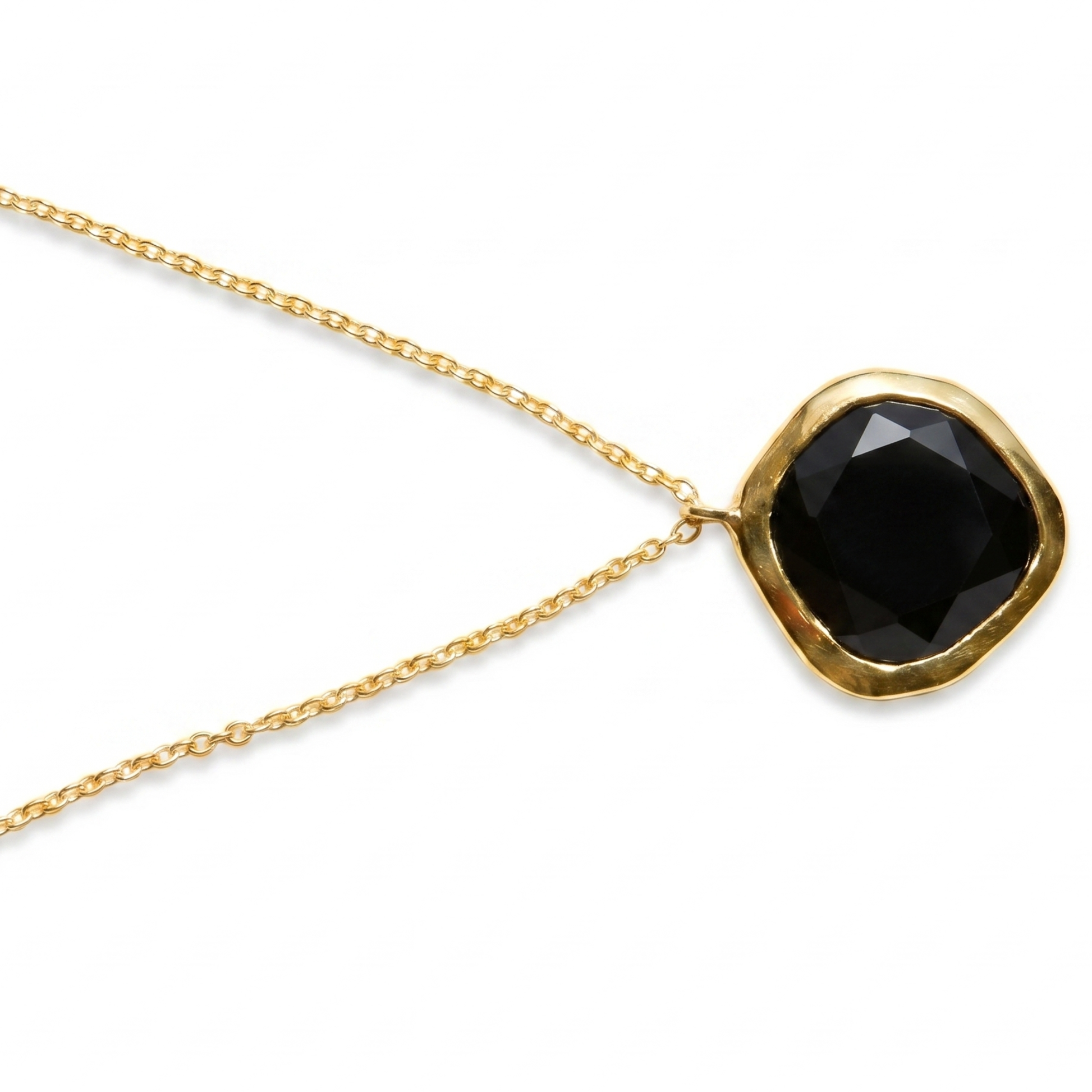Detailed close-up of the Bold Calm pendant highlighting the deep facets of the irregular square black onyx stone set in 18kt gold plated sterling silver.
