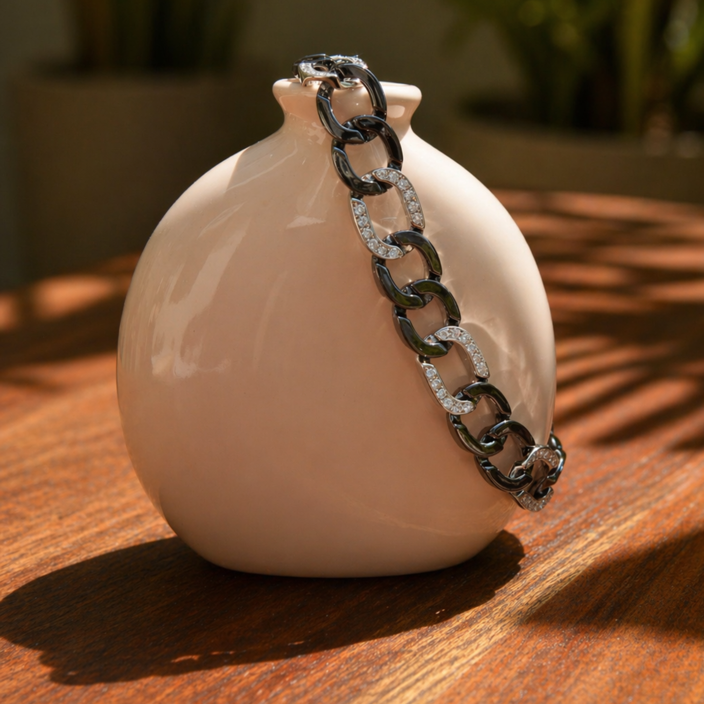 The Effortless Edge link bracelet displayed on a minimal beige ceramic vase, highlighting the contrast between the substantial silver links and the soft studio lighting.