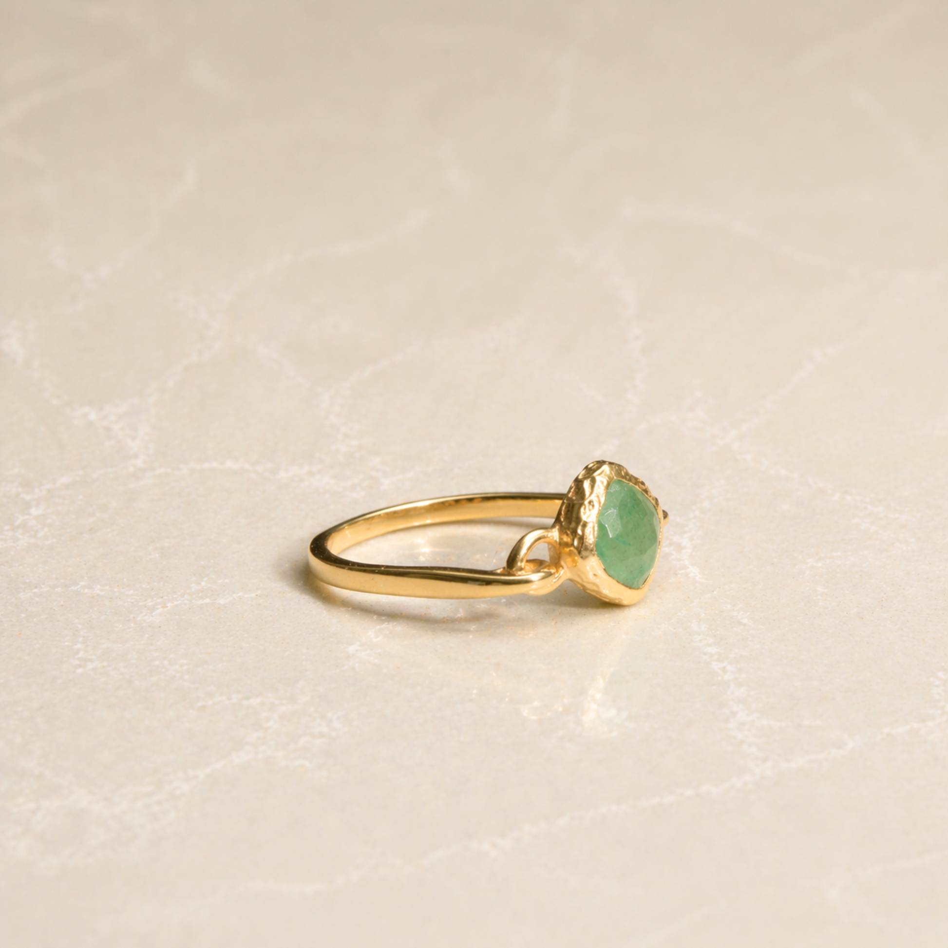 Side profile of the handcrafted Calm Aura Ring, highlighting the polished golden finish and the structured lines of the green aventurine setting.
