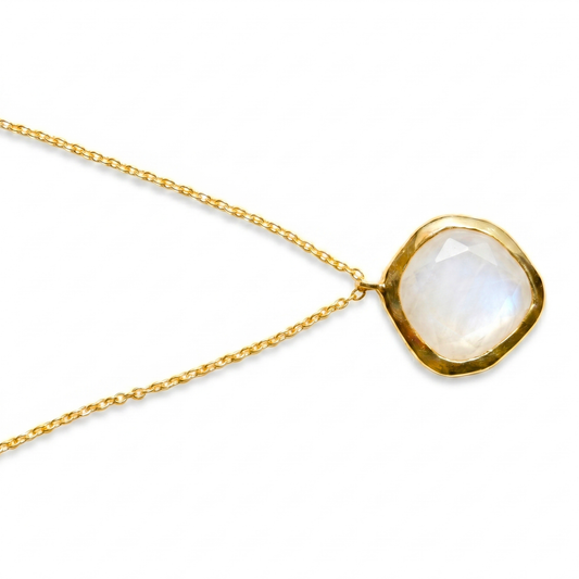 A detailed close-up of the Earthy Glow pendant highlighting the warm, creamy tones of the cappuccino moonstone and the slightly irregular, organic gold-plated frame.