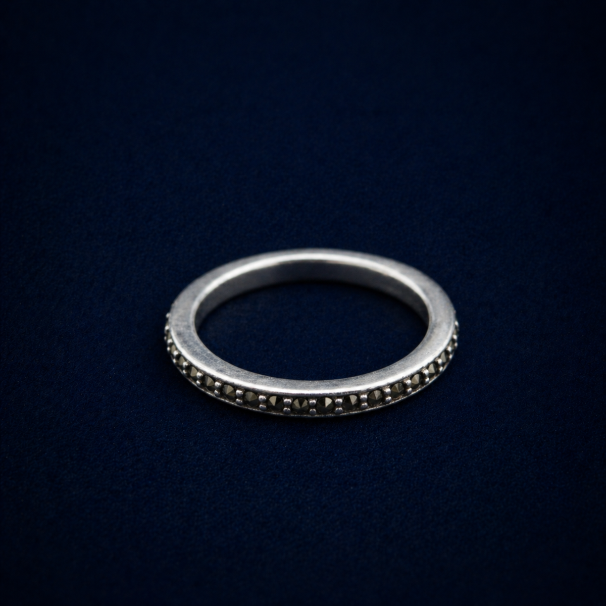 A detailed perspective shot of the Everyday Sparkle Ring, displaying the shimmering cubic zirconia stones set into a thin, modern sterling silver eternity-style band.