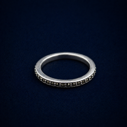 A detailed perspective shot of the Everyday Sparkle Ring, displaying the shimmering cubic zirconia stones set into a thin, modern sterling silver eternity-style band.