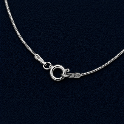 Macro close-up of the Flat Drift necklace highlighting the secure lobster clasp, 925 authenticity hallmarks, and the smooth, reflective texture of the wide flat snake chain links.
