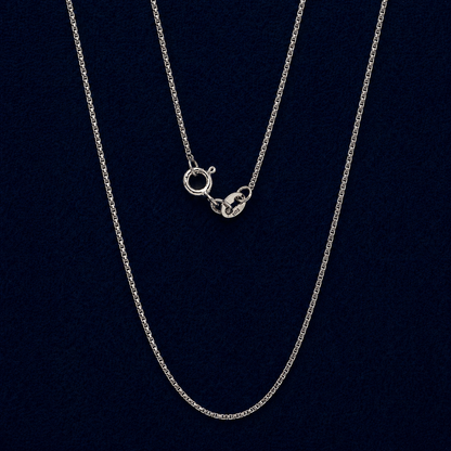 A full view of the handcrafted 925 sterling silver Gridline Chain, featuring delicate small square-shaped links and a neat, structured design against a dark navy background.